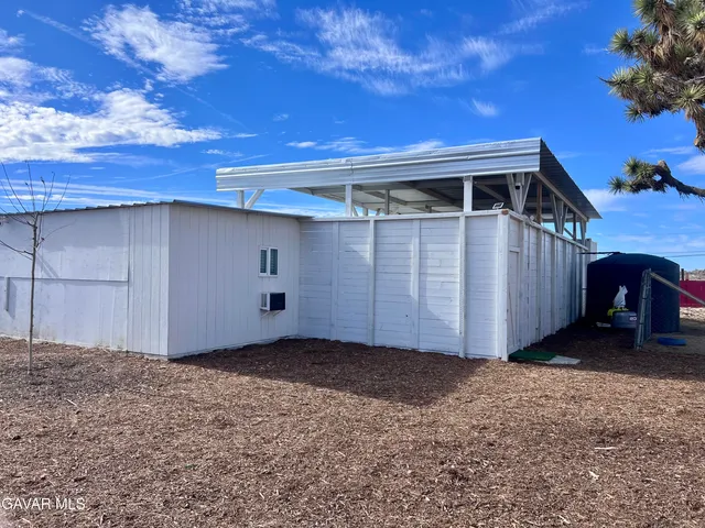 a utility room with stainless steel appliances wooden floor and sink