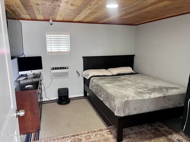 a kitchen with a refrigerator and a wooden cabinets