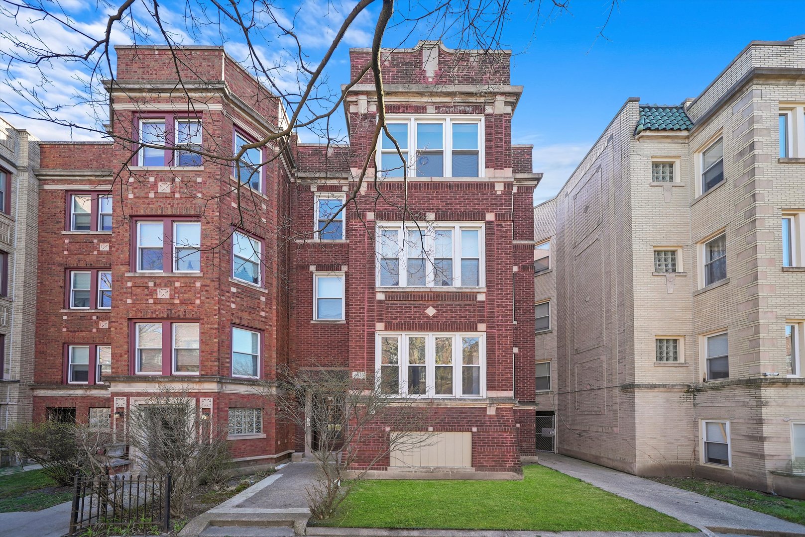 a view of a brick building next to a yard