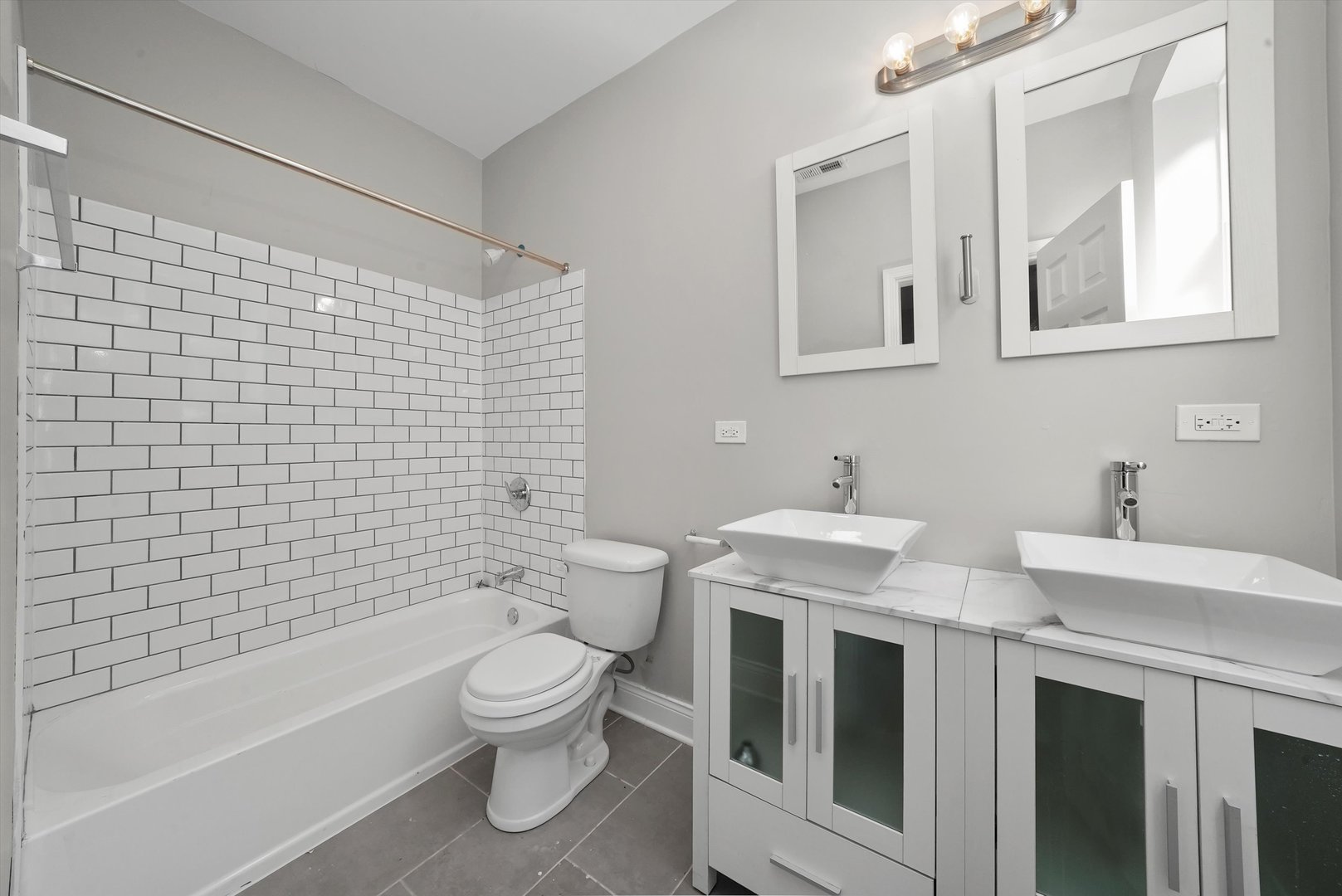 6833 South Merrill Avenue, Unit 1 Chicago, IL 60649 - Photo 6 of 10 a bathroom with a toilet a sink and bathtub
