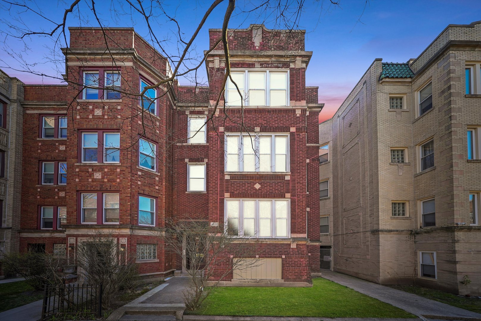 6833 South Merrill Avenue, Unit 1 Chicago, IL 60649 - Photo 10 of 10 a front view of a building with a yard