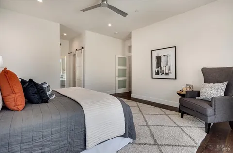 a view of walk in closet with wooden floor
