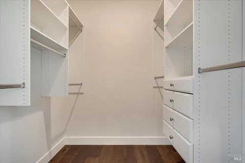 a view of a patio with couches table and chairs under an umbrella with a fire pit
