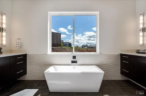 a view of a chairs and table in the back yard