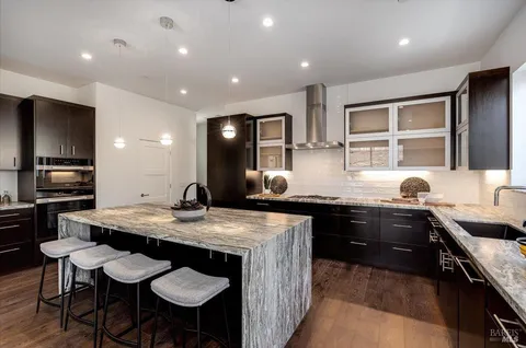 a view of living room and kitchen with wooden floor
