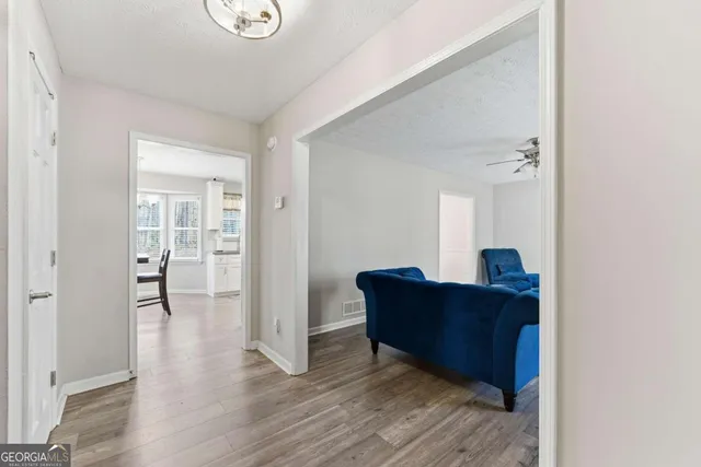 a living room with furniture and wooden floor