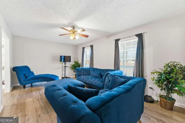 a living room with furniture potted plant and a window
