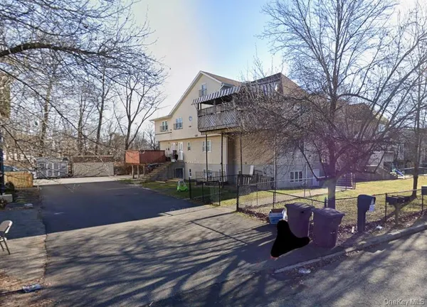 a view of a house with pool and snow on the side of the road