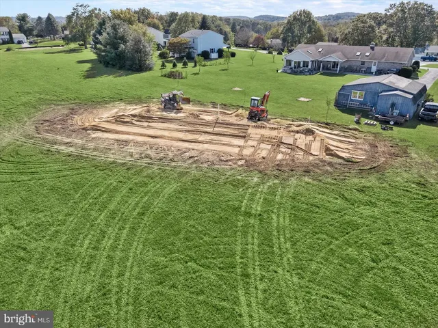 an aerial view of a houses with a yard