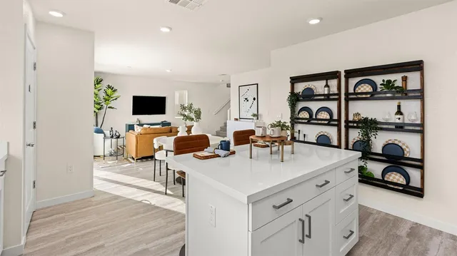 a living room with furniture a rug and a flat screen tv