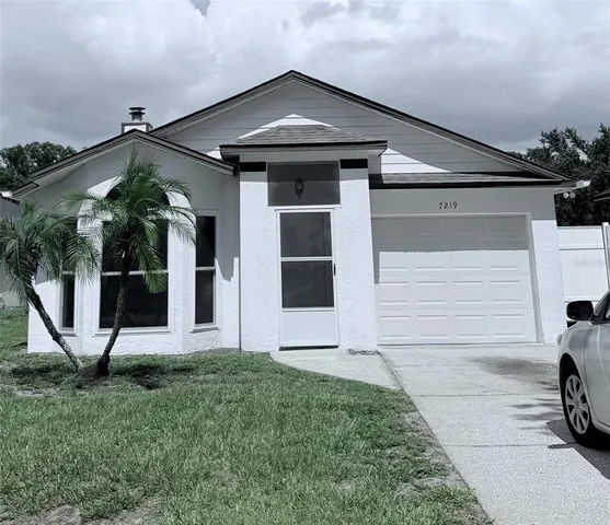 a view of a house with a small yard and large window