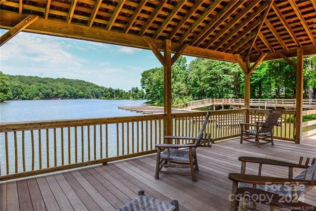10601 Wildlife Road Charlotte, NC 28278 - Photo 21 of 31 a view of a roof deck with wooden floor and outdoor seating