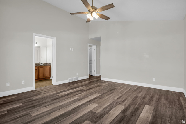 1836 West 800 North Mapleton, UT 84663 - Photo 15 of 38 Unfurnished living room featuring vaulted ceiling, dark wood finished floors, and a ceiling fan