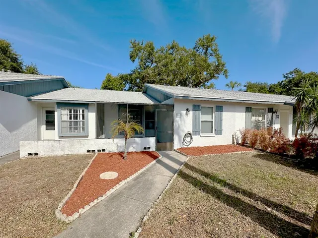a front view of a house with a garden and patio