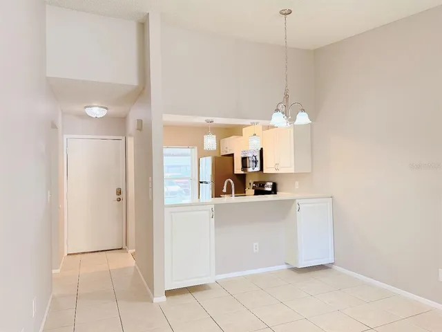 a kitchen with cabinets and window