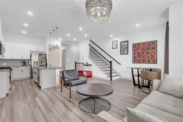 a living room with furniture and kitchen view