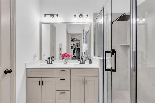 a bathroom with a sink vanity and a mirror