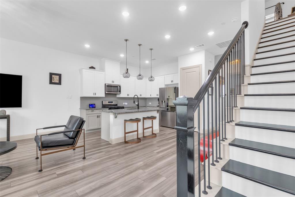 4153 Shavano Drive Frisco, TX 75034 - Photo 24 of 35 a view of kitchen with cabinets and wooden floor