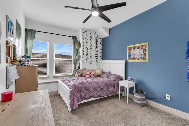 a spacious bedroom with a bed and a chandelier