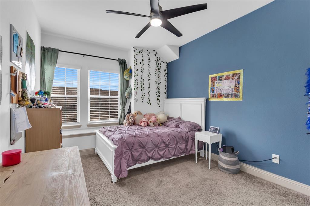 4153 Shavano Drive Frisco, TX 75034 - Photo 28 of 35 a spacious bedroom with a bed and a chandelier