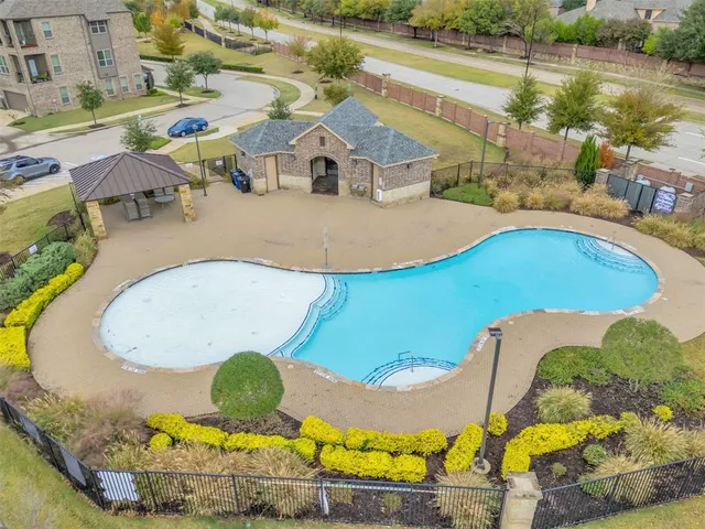 a view of a swimming pool with a table and chairs