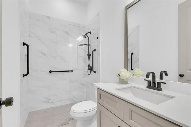 a bathroom with a sink toilet and shower