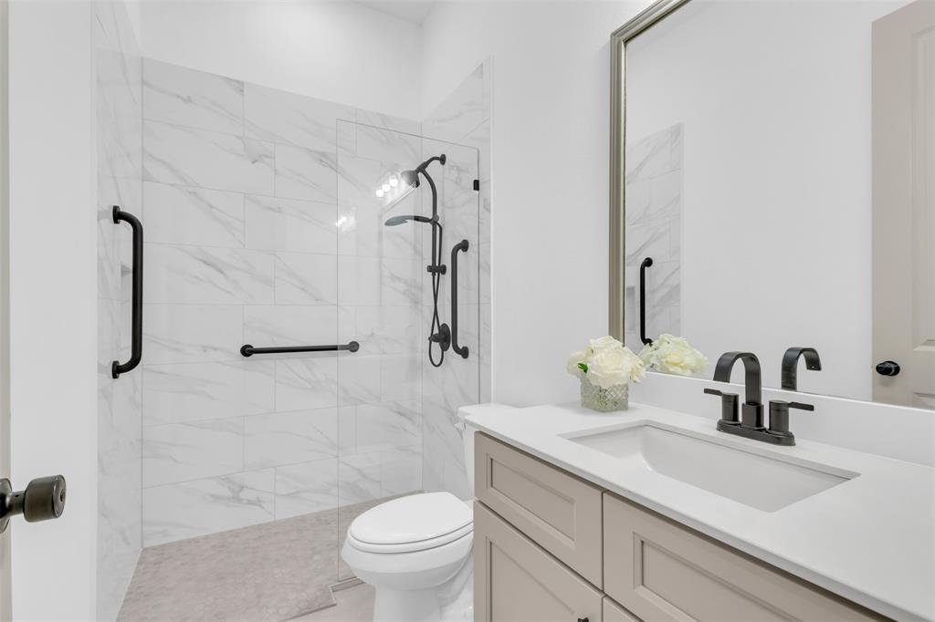 4153 Shavano Drive Frisco, TX 75034 - Photo 8 of 35 a bathroom with a sink toilet and shower