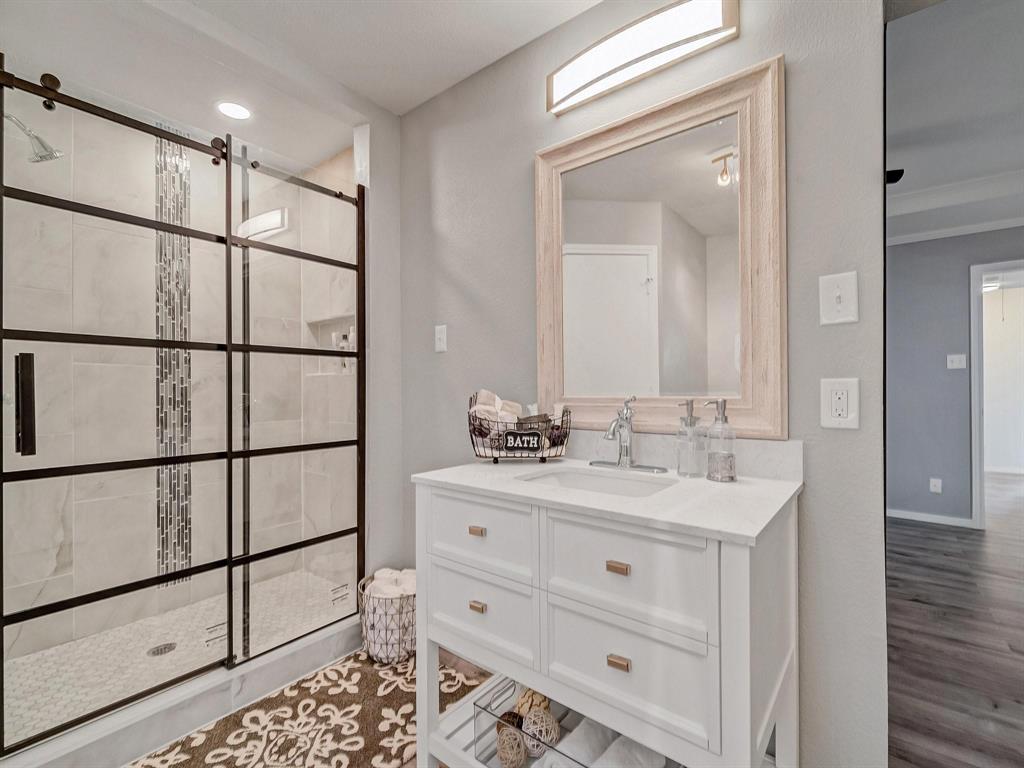 3105 Regency Carrollton, TX 75007 - Photo 12 of 18 a bathroom with a double vanity sink mirror and shower