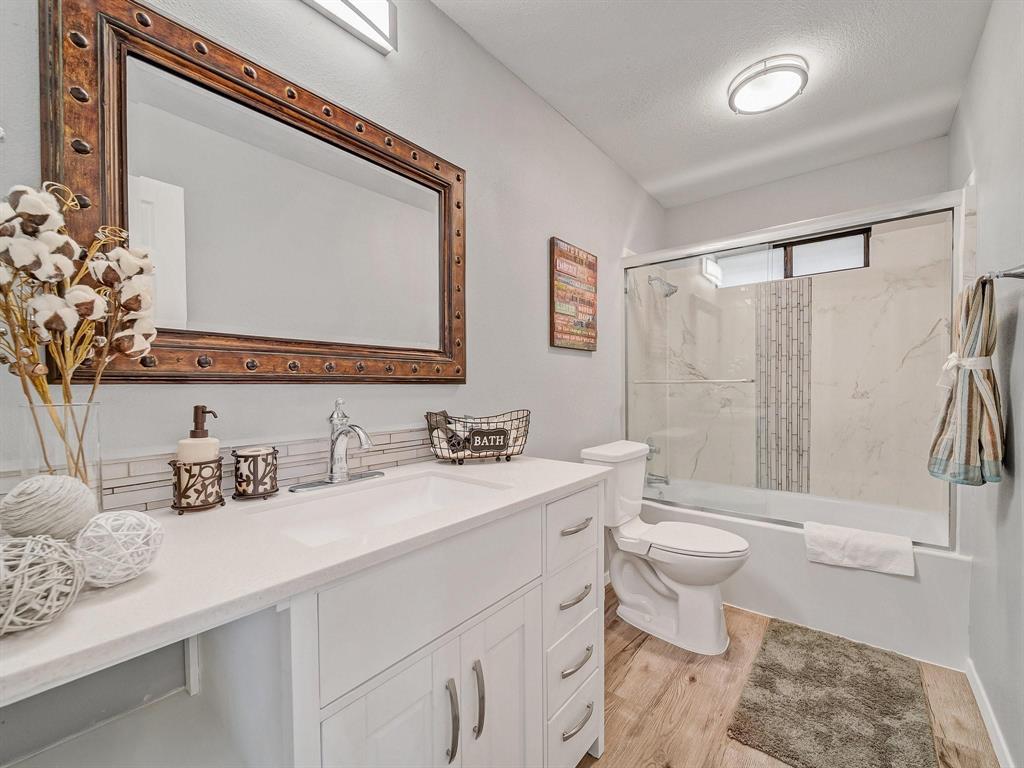 3105 Regency Carrollton, TX 75007 - Photo 15 of 18 a bathroom with a toilet sink and mirror