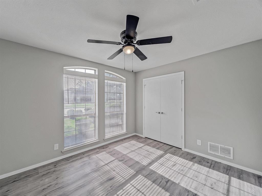 3105 Regency Carrollton, TX 75007 - Photo 16 of 18 a view of a livingroom with a ceiling fan and window