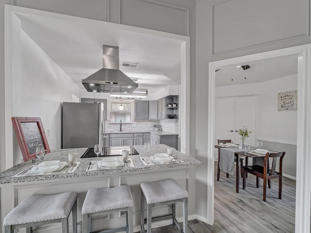 3105 Regency Carrollton, TX 75007 - Photo 5 of 18 a view of a dining room with furniture and wooden floor