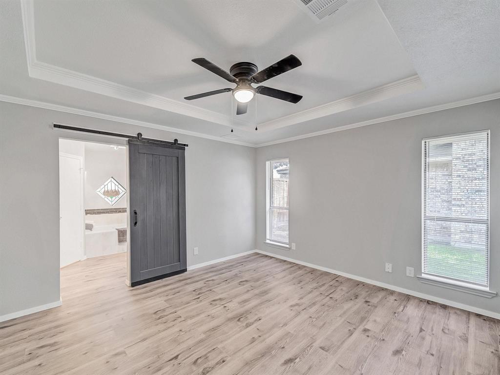 3105 Regency Carrollton, TX 75007 - Photo 10 of 18 a view of empty room with wooden floor and ceiling fan