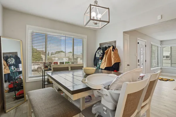 a living room with furniture a flat screen tv and a large window