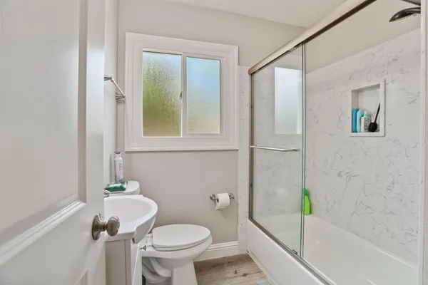 a bathroom with a sink toilet and shower