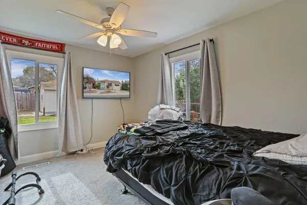 a bedroom with a bed and a window