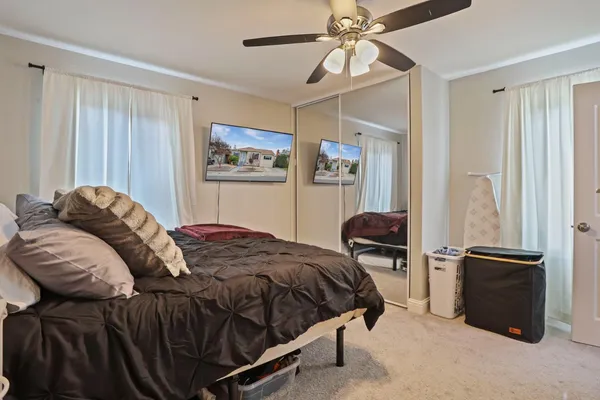 a bedroom with a bed and a chandelier