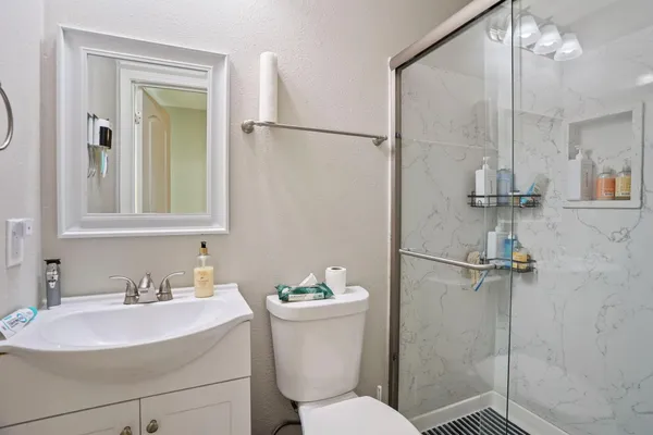 a bathroom with a sink toilet and shower