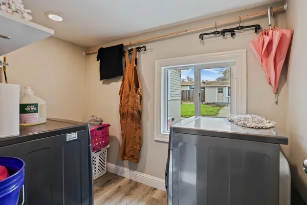 a room with furniture a flat screen tv and a view of kitchen