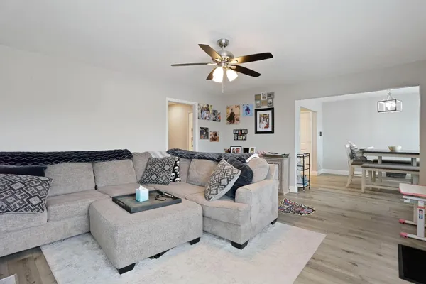 a living room with furniture and a wooden floor