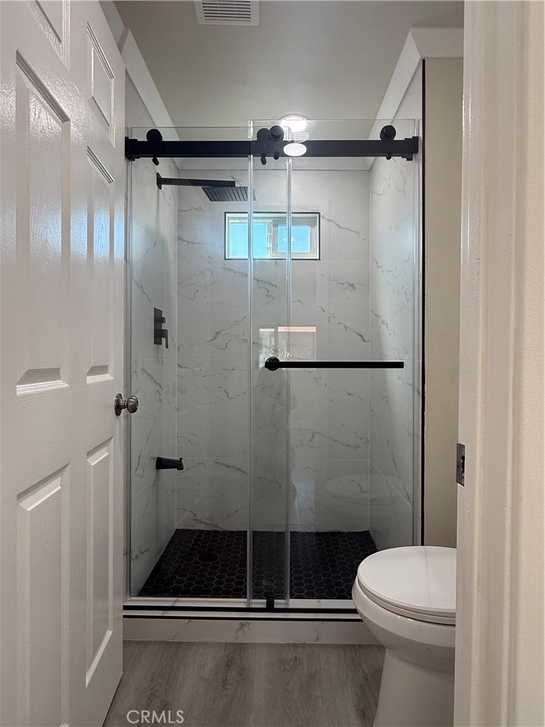 7700 Lampson Avenue, Unit 52 Garden Grove, CA 92841 - Photo 3 of 11 a bathroom with a toilet and a shower