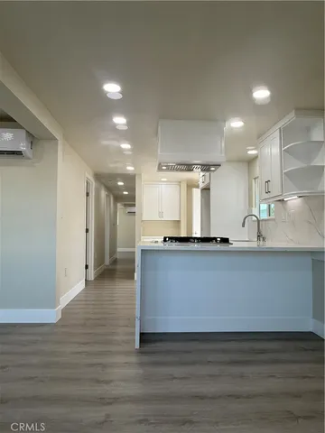 a kitchen with cabinets and window