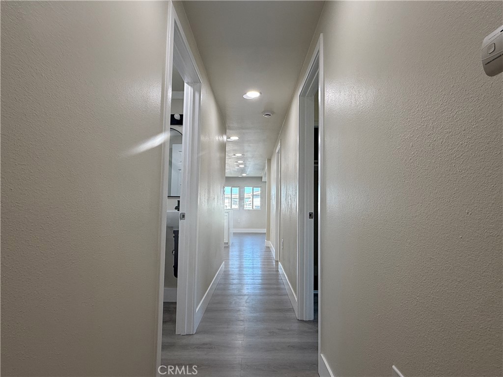 7700 Lampson Avenue, Unit 52 Garden Grove, CA 92841 - Photo 10 of 11 a view of a hallway with wooden floor