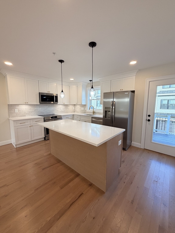 9 Acton Road, Unit 10 Chelmsford, MA 01824 - Photo 12 of 15 a large kitchen with stainless steel appliances granite countertop a stove a sink and a refrigerator