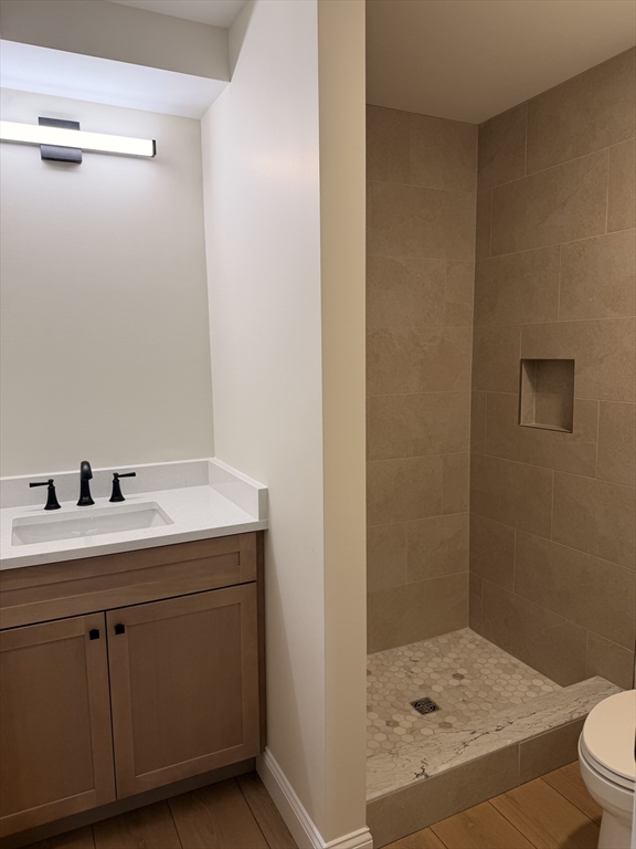 9 Acton Road, Unit 10 Chelmsford, MA 01824 - Photo 15 of 15 a bathroom with a sink a toilet and shower