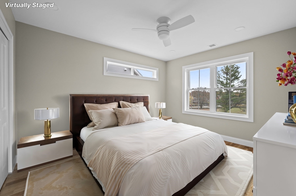 9 Acton Road, Unit 10 Chelmsford, MA 01824 - Photo 4 of 15 a bedroom with a large bed and a window