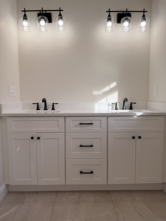 9 Acton Road, Unit 10 Chelmsford, MA 01824 - Photo 10 of 15 a bathroom with a sink vanity and mirror