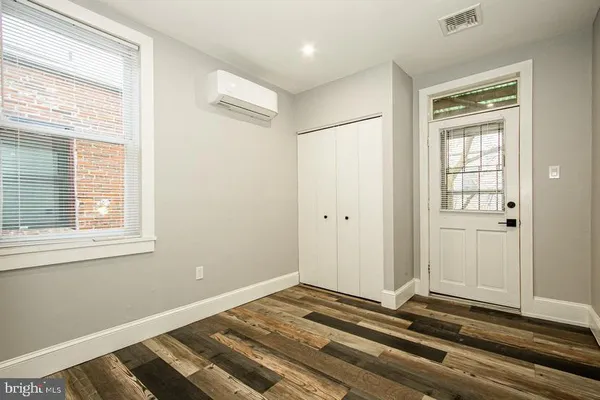 a view of a room with wooden floor and windows
