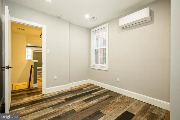 a view of a room with wooden floor and bedroom