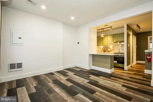 a bedroom with a bed and a view of kitchen