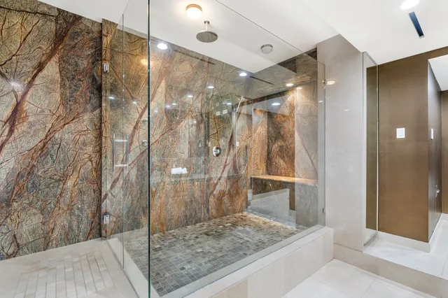 a large bathroom with a large tub and shower